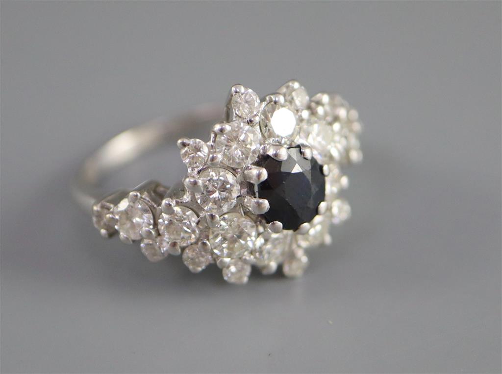 A modern 18ct white gold, sapphire and diamond cluster dress ring, with diamond set shoulders,